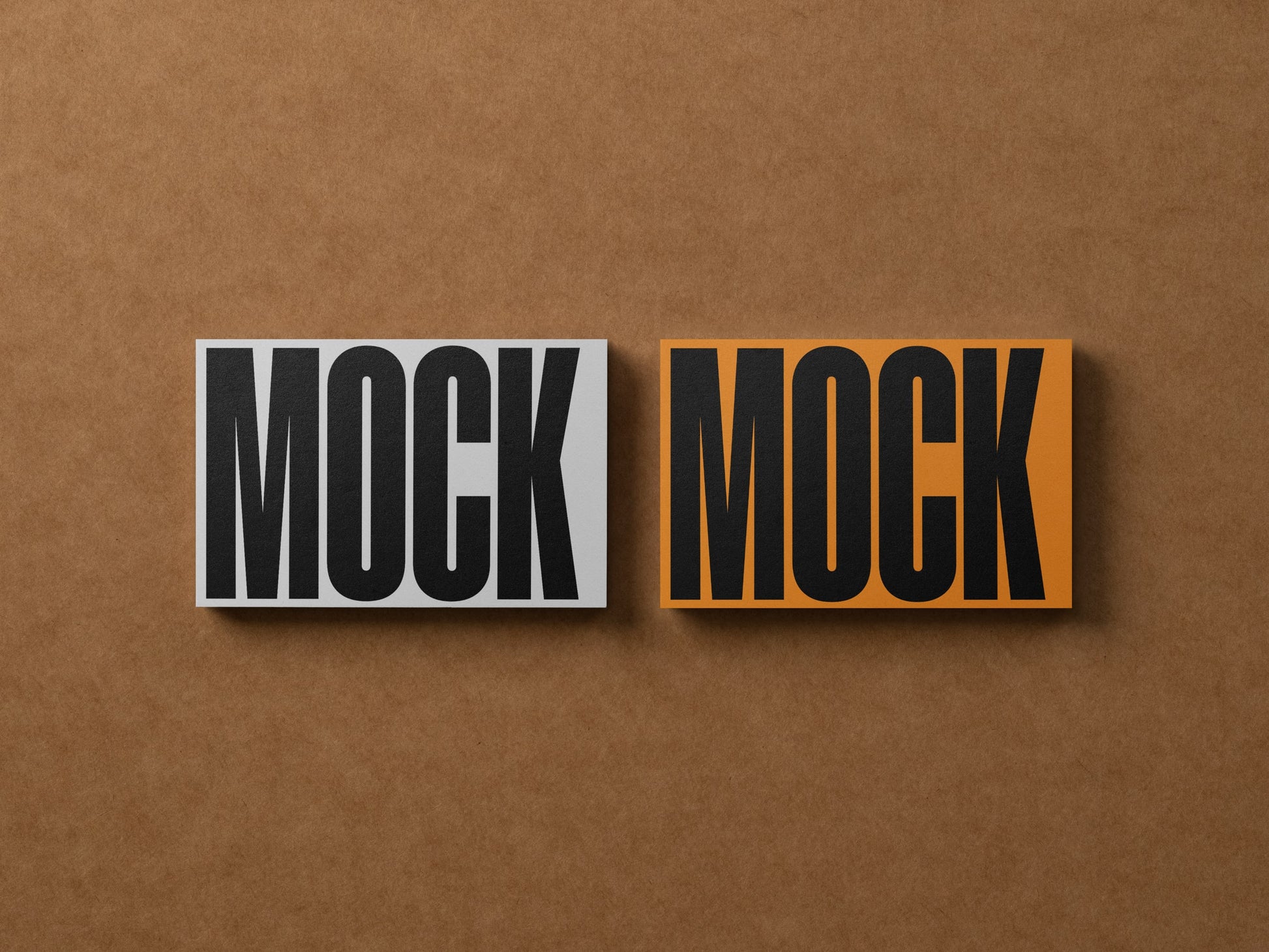 Two business card mockups side by side, gray MOCK and orange MOCK variants