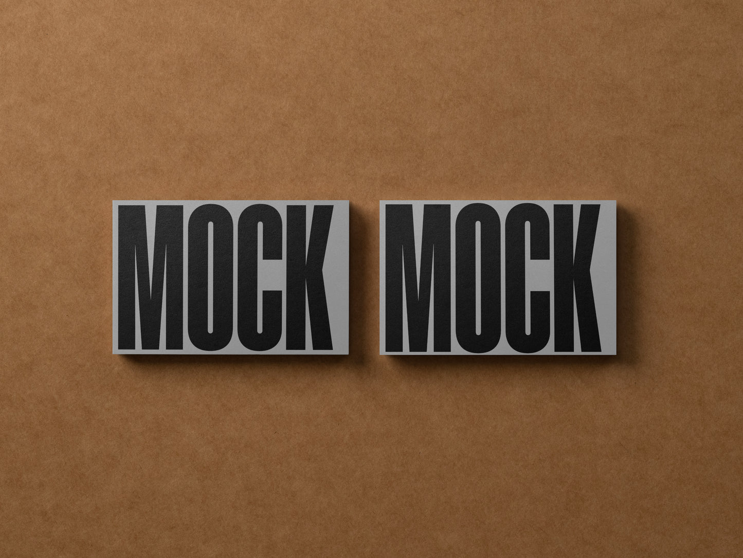 Business cards with 'MOCK' text, two side-by-side in dark gray tones