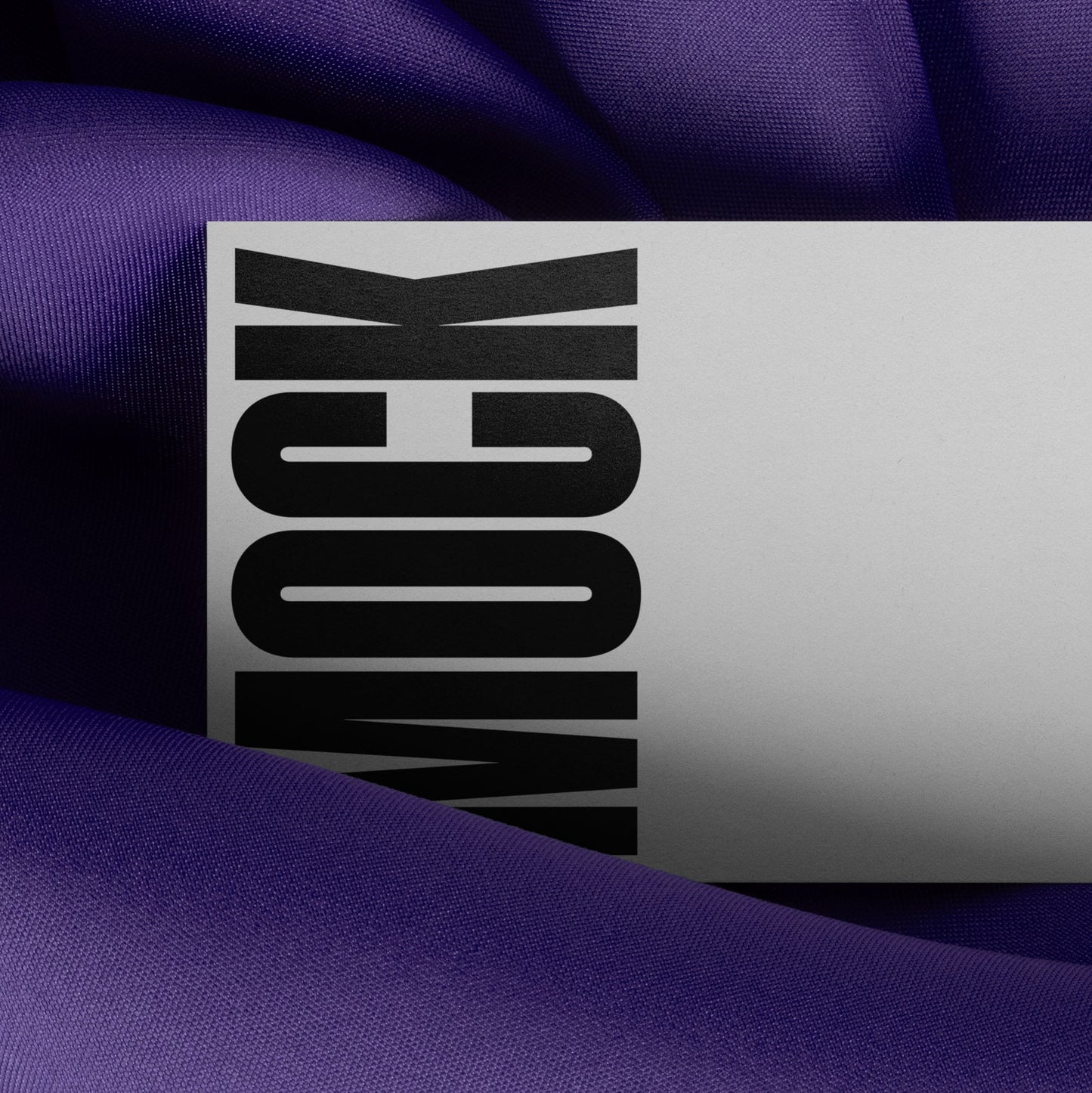 Branding mockup featuring stationery print items, showing a business card design on a blue background made of cloth fabric. Created by Sylvan Hillebrand.