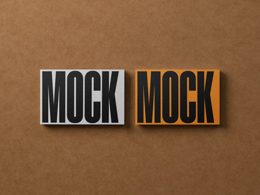 Business cards with 'MOCK' text, two side-by-side with orange border accent