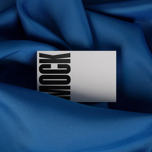 Blue draped cloth with partially visible white stationery card and black branding block