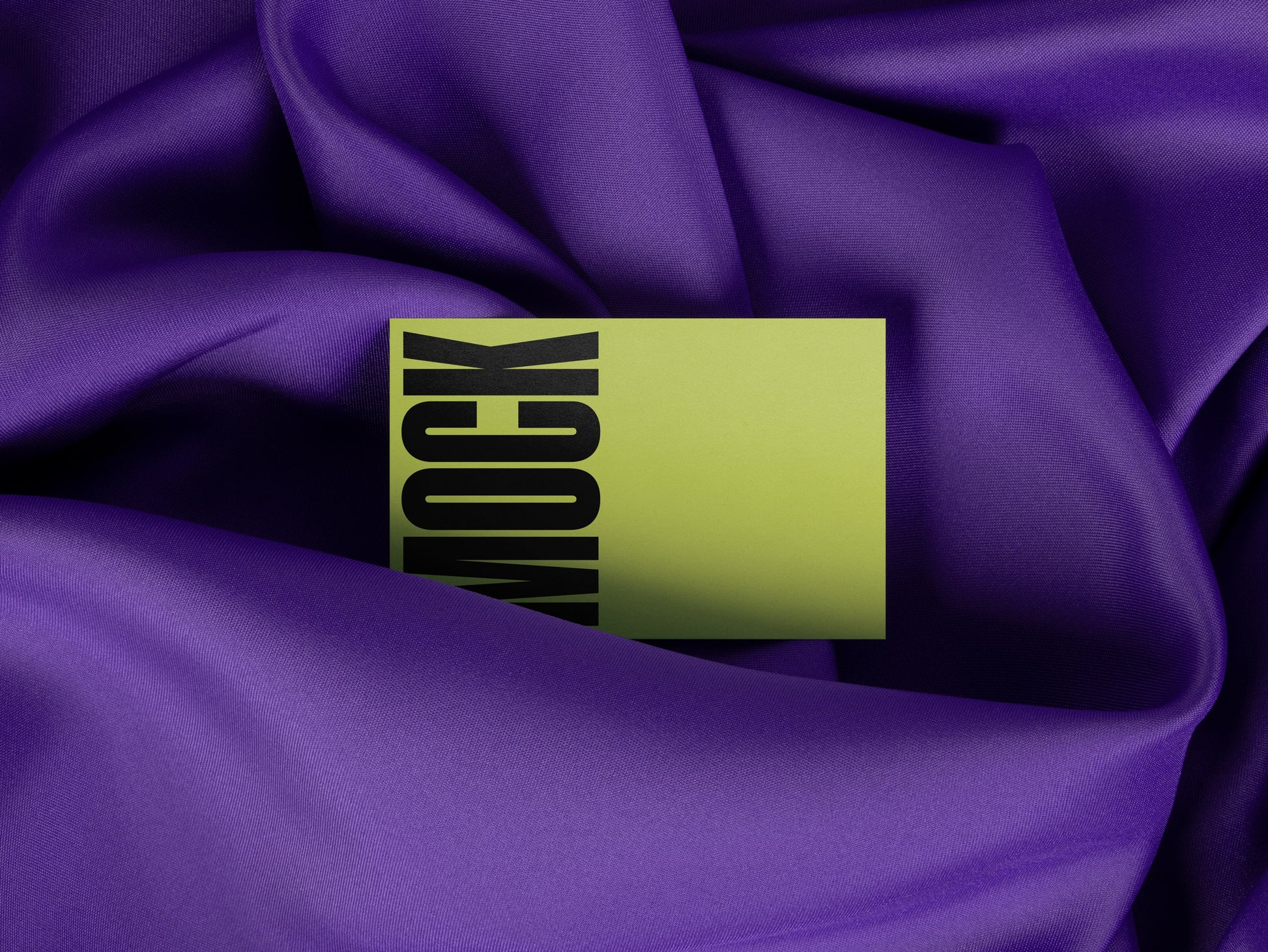 Branding mockup featuring stationery print items, showing a business card design on a blue background made of cloth fabric. Created by Sylvan Hillebrand.