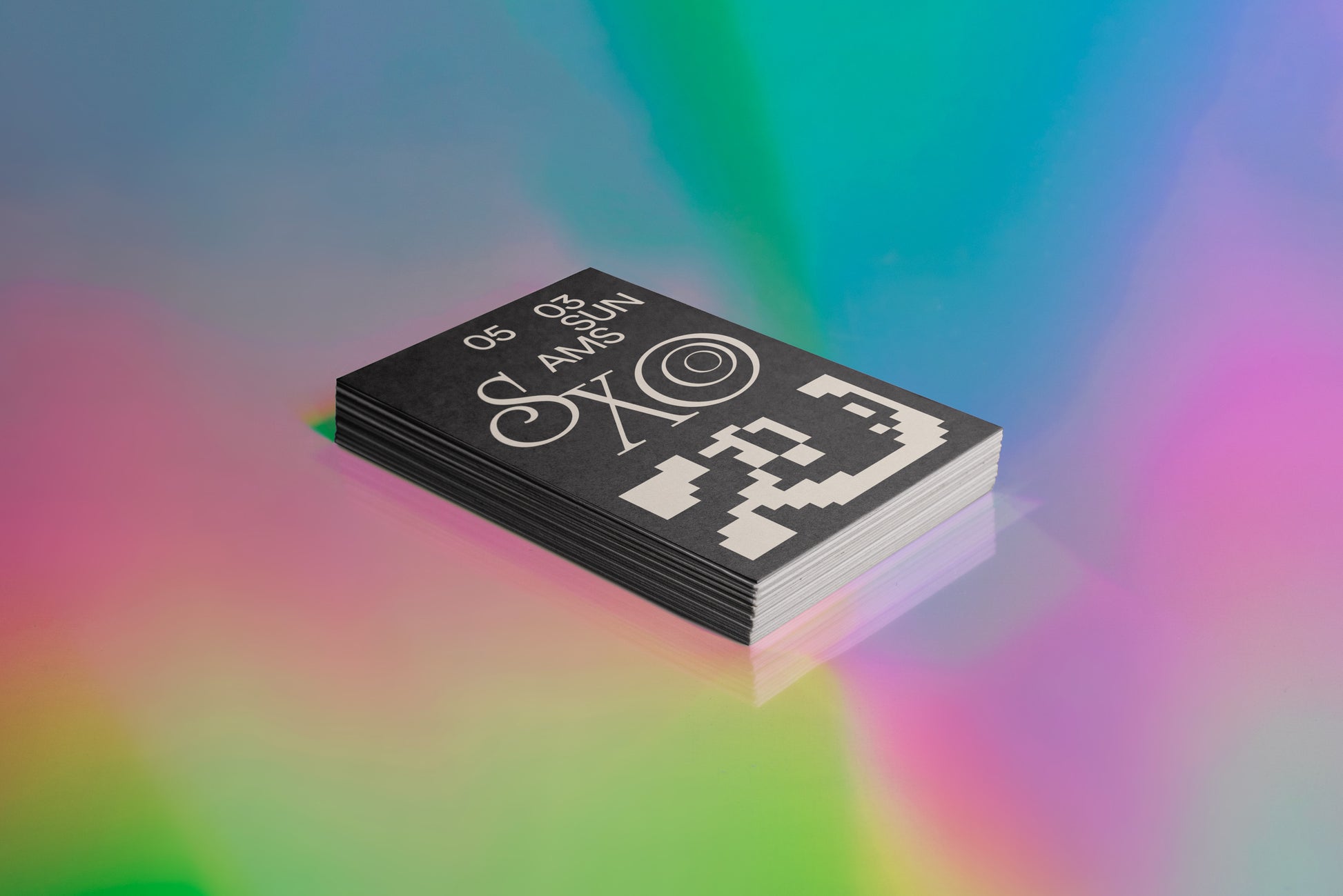 Business card mockup: dark business card stack with pixel icon pattern and emblem