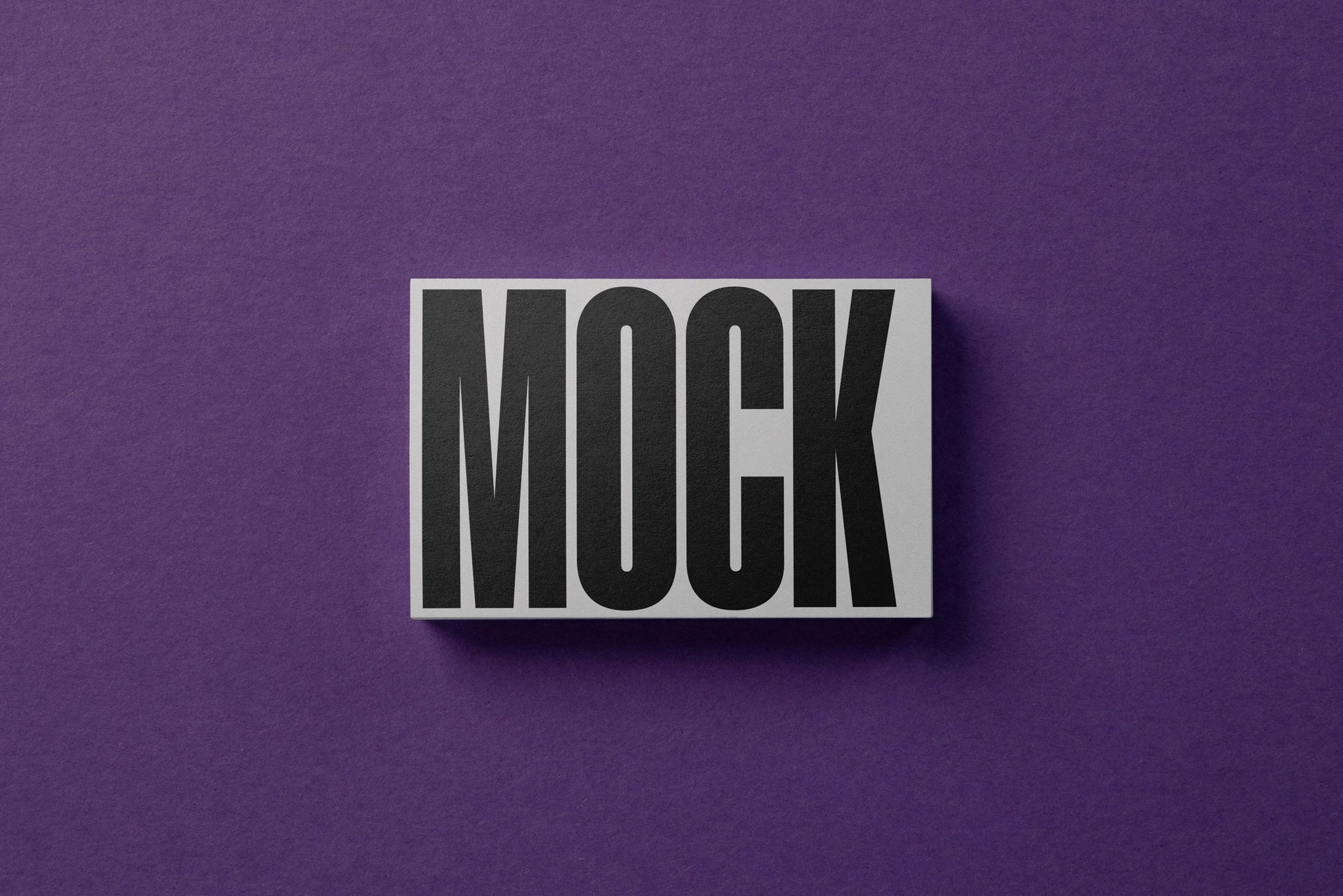 A business card mockup on a paper background
