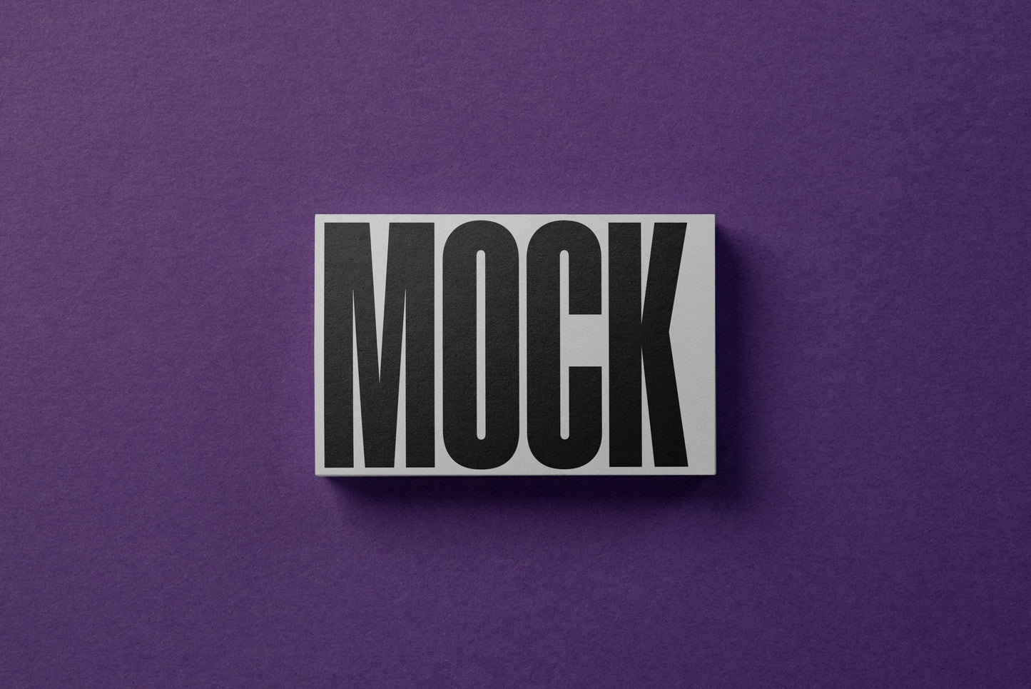 White business card mockup with MOCK text, small angled view