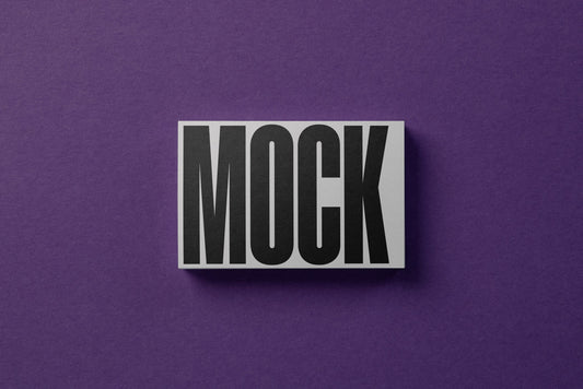 White business card mockup with MOCK text, small angled view