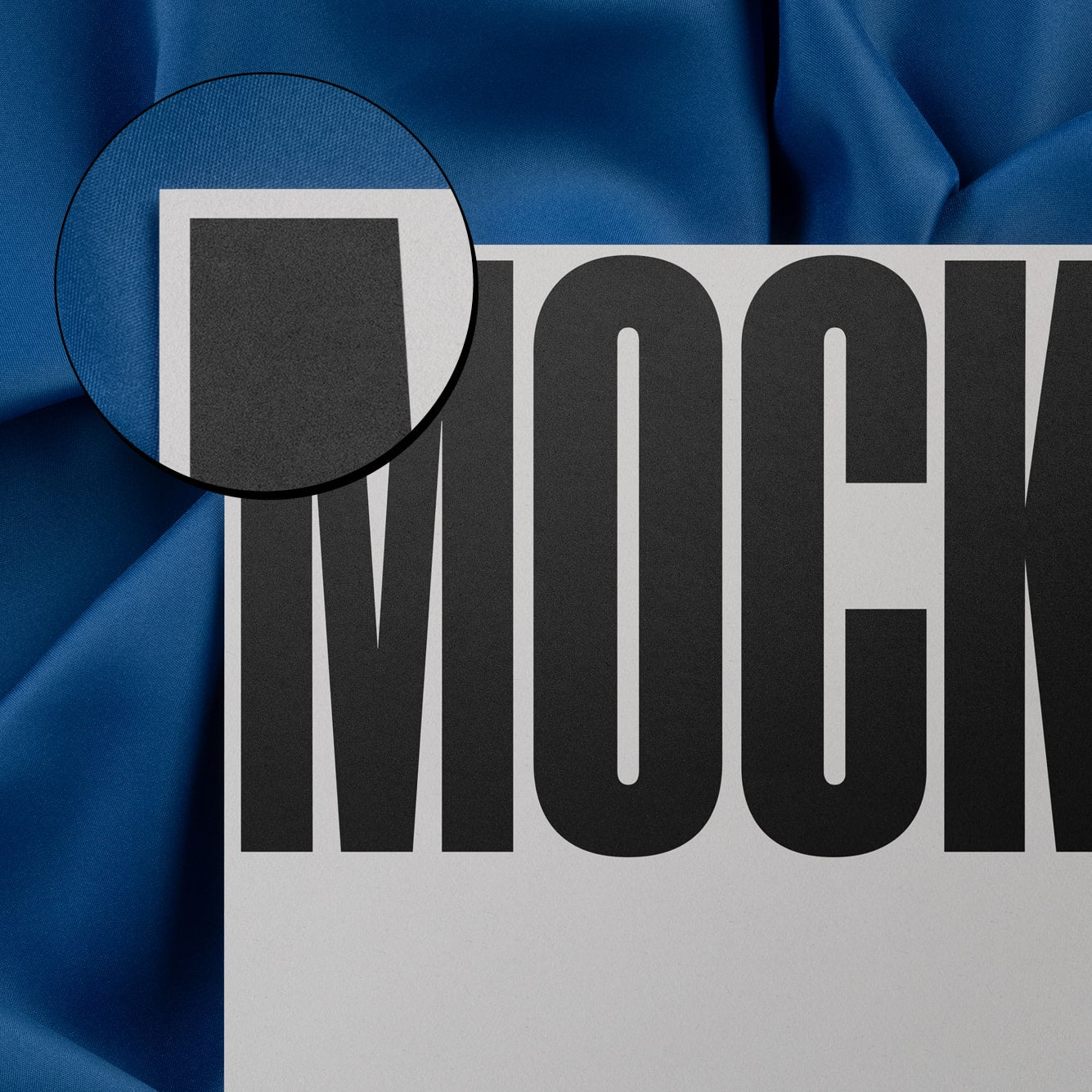 High-quality mockup featuring stationery print items, showing a detail of a card on a blue background made of cloth fabric. Created by Sylvan Hillebrand.